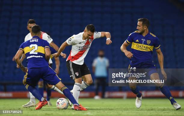 River Plate's Colombian Rafael Santos Borre is marked by Boca Juniors' Lisandro Lopez and Nicolas Capaldo during their Argentine Professional...