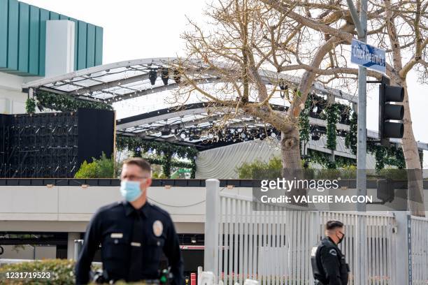 Policemen stand in front of the entrance of the Los Angeles Convention Center wherethe 63rd Annual Grammy Awards is set up, in Los Angeles,...
