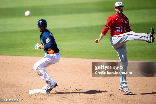 Washington Nationals non-roster invitee infielder Jordy Mercer tags out Houston Astros infielder Robel Garcia at second base and throws the ball to...