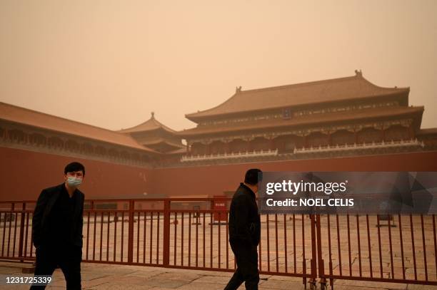 People walk near the entrance of the Forbidden City during a sandstorm in Beijing on March 15, 2021.