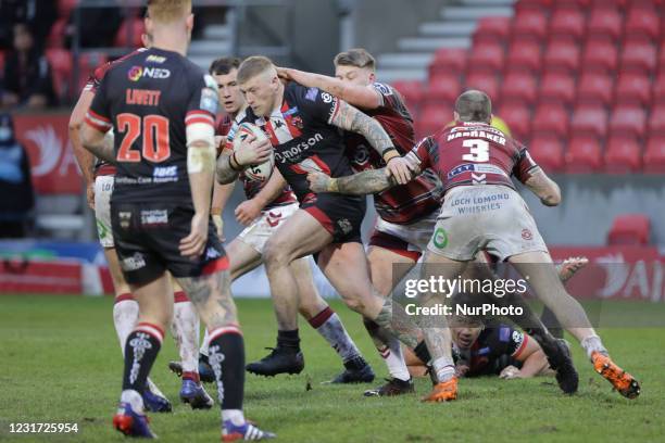 Danny Addy of Salford Red Devils runs with the ball during the pre-season match between Salford Red Devils and Wigan Warriors at AJ Bell Stadium,...