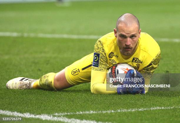 Reims' Serbian goalkeeper Predrag Rajkovic secures the ball during the French L1 football match between Stade de Reims and Olympique Lyonnais at the...
