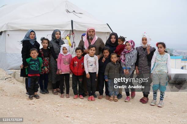 Year-old Mohammed Khatib who had to flee from his home in Maardibse village with his family to seek refuge at camps, poses for a photo with his...