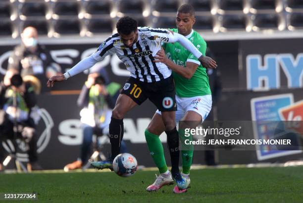 Angers' French midfielder Angelo Fulgini and Saint-Etienne's French forward Kevin Monnet-Paquet fight for the ball during the French L1 Football...