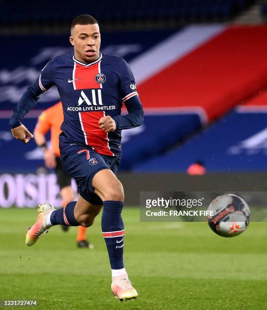 Paris Saint-Germain's French forward Kylian Mbappe runs after the ball during the French L1 football match between PSG and Nantes at the Parc des...
