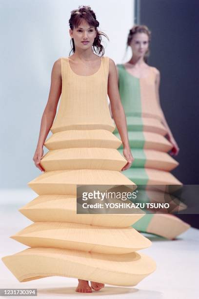 Models display Pleats please dresses with wired hoops as part of Issey Miyake Spring-Summer 1995 ready-to-wear collection in Paris on November 4,...