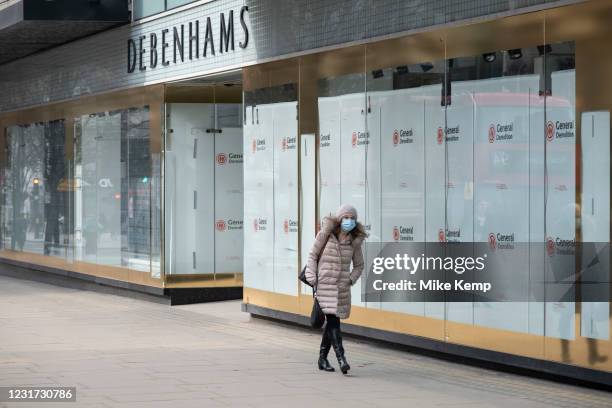 Very few people out along Oxford Street pass Debenhams, which is now completely closed down with the name of a demolision company in the windows as...