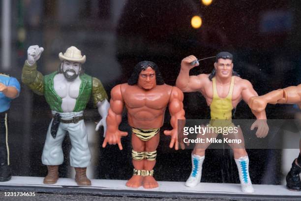 Plastic action figures of wrestling characters in the window of a bar on 5th March 2021 in London, England, United Kingdom. Some of the figures are...