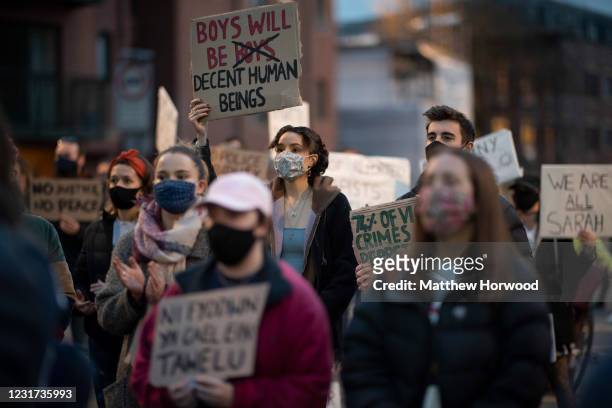 Woman holds a sign in the air outside Cardiff Bay police station during a protest on March 15, 2021 in Cardiff, Wales. Labour has announced it will...