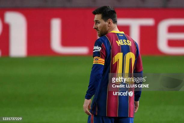 Barcelona's Argentinian forward Lionel Messi walks on the pitch during the Spanish League football match between Barcelona and SD Huesca at the Camp...