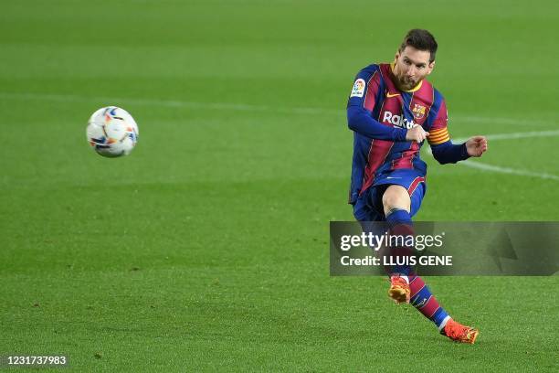 Barcelona's Argentinian forward Lionel Messi kicks the ball during the Spanish League football match between Barcelona and SD Huesca at the Camp Nou...