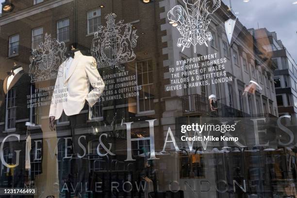 Shop window of famous tailors Gieves & Hawkes on Savile Row on 5th March 2021 in London, England, United Kingdom. Savile Row is a street in Mayfair,...