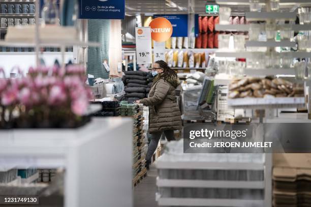 Customer makes purchases at an IKEA store in Amsterdam, on March 16, 2021. - Due to lifts of the coronavirus Covid-19 restrictions, stores can now...