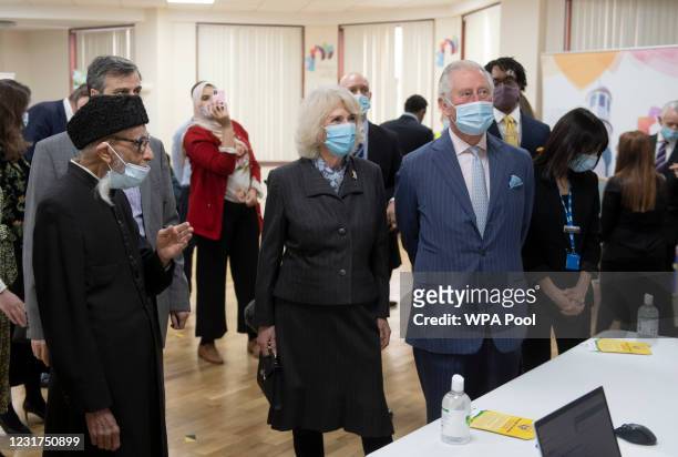 Prince Charles, Prince of Wales and Camilla, Duchess of Cornwall wear face masks as they visit a vaccination pop-up centre at Finsbury Park Mosque on...