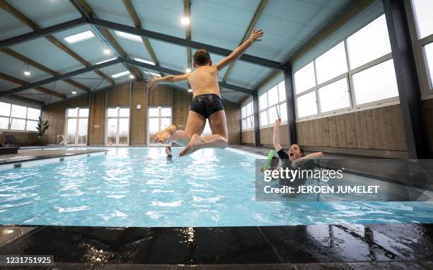 Child takes a swimming lesson at the Snorkeltje swimming school on March 16, 2021 in Nijkerk, after an ease of the measures against the COVID-19...