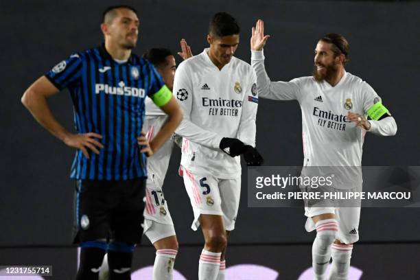 Real Madrid's Spanish defender Sergio Ramos celebrates his goal during the UEFA Champions League round of 16 second leg football match between Real...