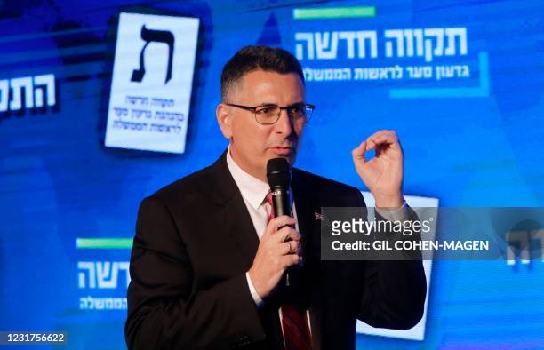Gideon Saar, head of Israel's New Hope party, speaks on stage near an Israeli flag during a campaign rally in the northern Israeli city of Haifa on...