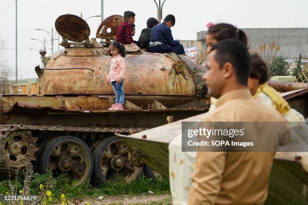 Children play with military vehicles that were used in the Iranian war and during the Halabja chemical attack. The 33rd anniversary of the chemical...