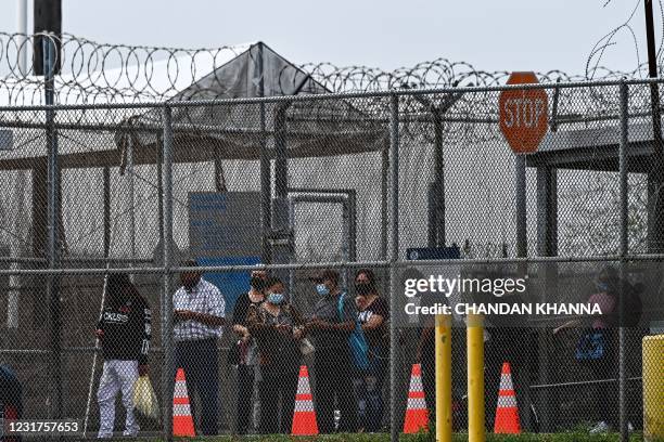 Migrants mostly form Central America wait in line to cross the border into the US at the Gateway International Bridge, between the cities of...