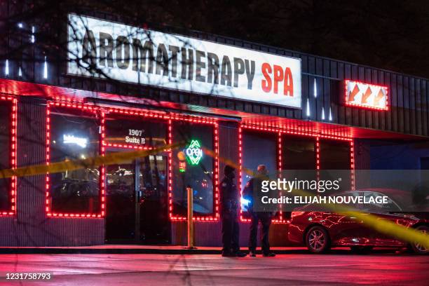 Law enforcement personnel are seen outside a massage parlor where a person was shot and killed on March 16 in Atlanta, Georgia. - Eight people were...