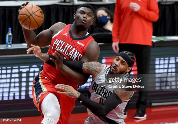 Carmelo Anthony of the Portland Trail Blazers fouls Zion Williamson of the New Orleans Pelicans during the second half at Moda Center on March 16,...