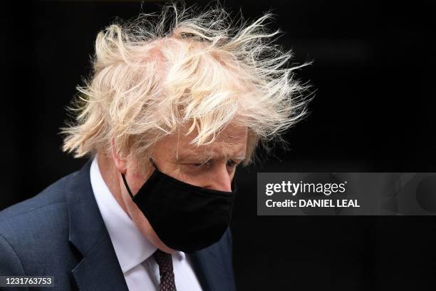 Britain's Prime Minister Boris Johnson, wearing a protective face covering to combat the spread of the coronavirus, leaves 10 Downing Street in...