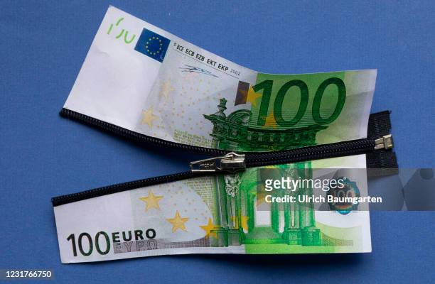 In this photo illustration an enlarged 100 euro banknote is divided by a zipper, on March 17, 2021 in Bonn, Germany.