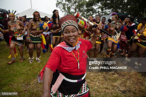 An elderly Zulu woman dances with maidens near the entrance to the palace moments after the body of King Goodwill Zwelithini arrived in Nongoma,...