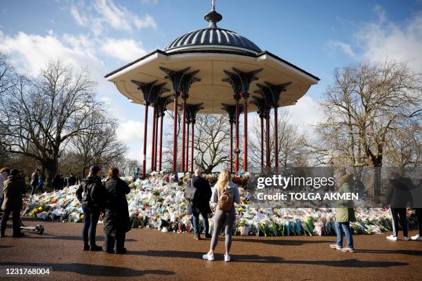 Well-wishers reflect alongside floral tributes in honour of Sarah Everard, the missing woman whose remains were found in woodland in Kent, at the...