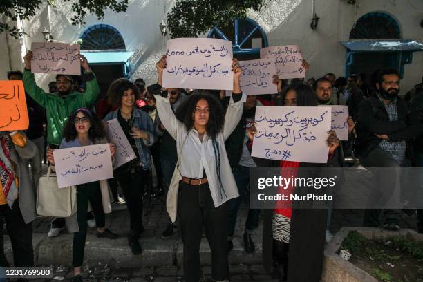 Protesters raise placards that read in Arabic, we queers are against all the retrograde Islamists, as others raise placards that read in Arabic,...