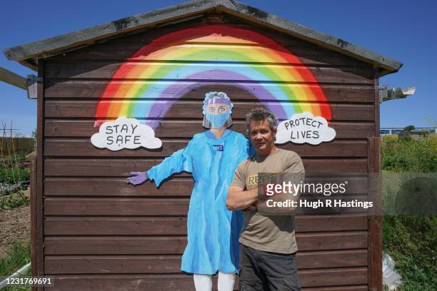 Furloughed hotel worker and part-time mural artist Jed Stone of Newquay, with the dedication to NHS staff he painted on the rear of a shed in the...
