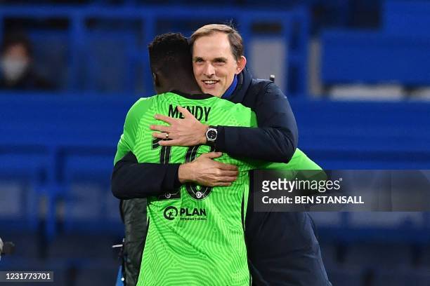 Chelsea's German head coach Thomas Tuchel and Chelsea's French-born Senegalese goalkeeper Edouard Mendy react at the final whistle during the UEFA...