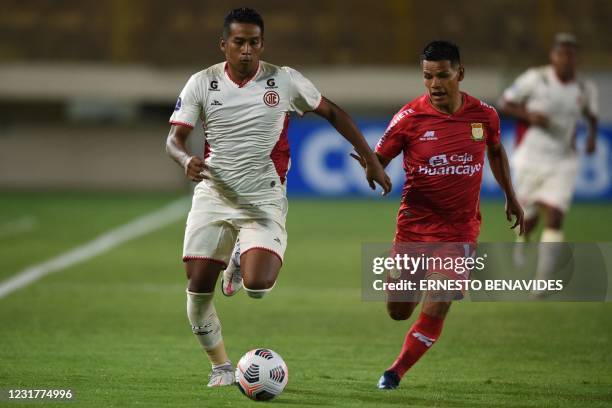 Peru's Cajamarca defender Josué Estrada and Peru's Sport Huancayo Daniel Morales vie for the ball during their Copa Sudamericana football tournament...