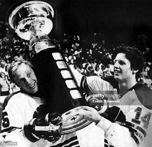 Ulf Nilssen and Anders Hedberg of the Winnipeg Jets hold up the Avco World Trophy after the Jets defeated the New England Whalers in Game 4 of the...