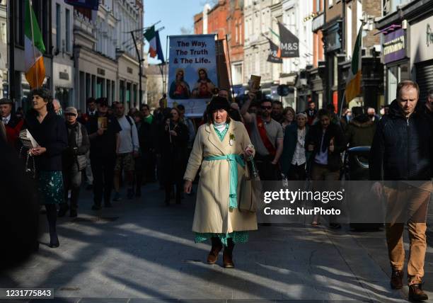People take part in a religious procession through Dublin city center, with worshipers carrying a statue of Our Lady of Fatima, on St. Patrick's Day,...