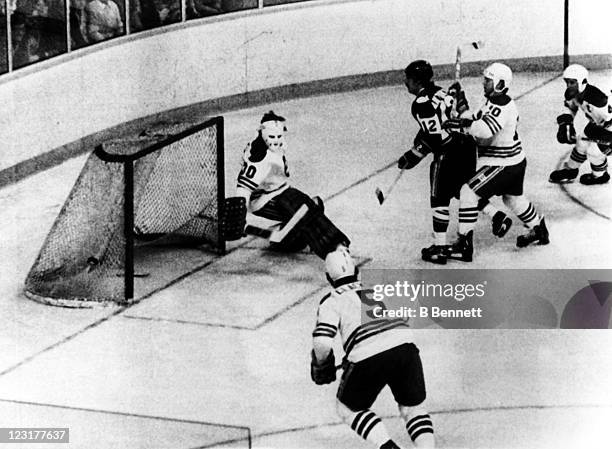 Goalie Gary Bromley of the Winnipeg Jets makes the save off of Mike Antonovich of the New England Whalers as Peter Sullivan of the Jets pushes him...