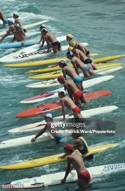 Boys with their surfboards waiting to compete at the Surf Lifesavers' Carnival on Freshwater Bay, Sydney, circa December 1984.