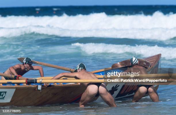 Bare-cheeked surf lifesavers preparing to launch their rescue boat during the Freshwater Surf Lifesavers' Carnival, Sydney, Australia, circa December...