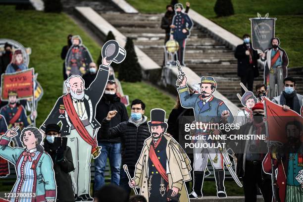 Silhouettes of the Communards and the Communardes created by the artist Dugudus are presented in front of the Sacré Coeur Basilica in Paris, on March...