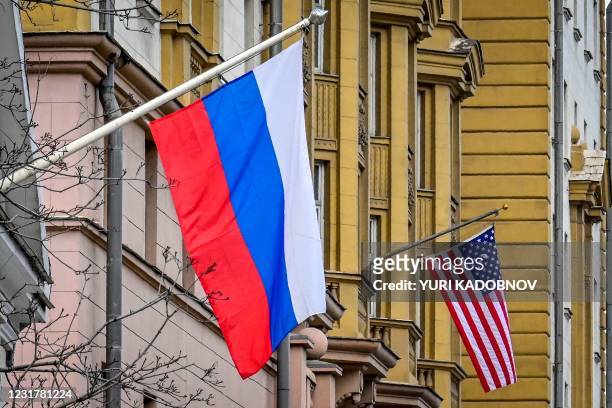 Russian flag flies next to the US embassy building in Moscow on March 18, 2021. - Moscow demanded on March 18 an apology over US President Joe...