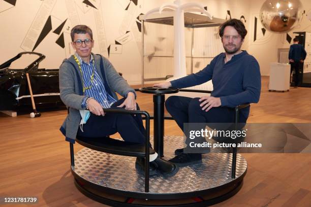 March 2021, Hamburg: Tulga Beyerle, director, and Friedrich von Borries, curator and initiator, sit in a carousel in the exhibition "School of...