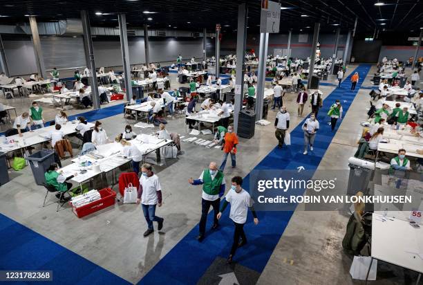 Volunteers count the votes for the parliamentary elections at candidate level in De Jaarbeurs in Utrecht on Mach 18 2021. - Dutch Prime Minister Mark...