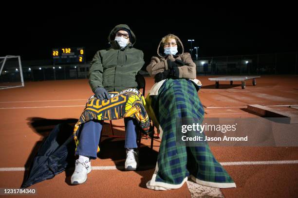 Caroline and Raymond Burt Grand parents of middle line backer Nathan Burt of Los Alamitos enjoys the game socially distanced from other fans on...