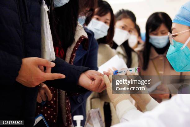 Medical workers conduct hepatitis C antibody screening in Nanjing, capital of east China's Jiangsu Province, March 18, 2021.