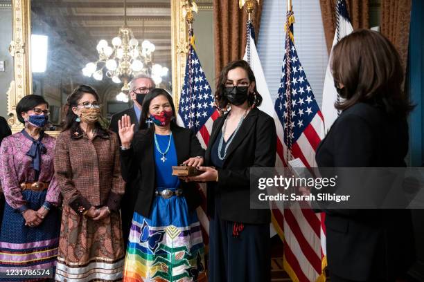 Vice President Kamala Harris conducts the ceremonial swearing in of Secretary of the Interior Deb Haaland as her daughter Somah Haaland holds the...