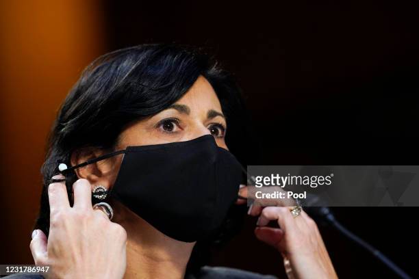 Dr. Rochelle Walensky, director of the adjusts her face mask during a Senate Health, Education, Labor and Pensions Committee hearing on the federal...