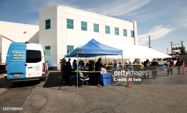 Patients line up to receive the Pfizer COVID-19 vaccine as the city of Vernon Health Department staff used the city's new mobile health unit clinic...