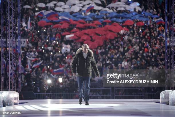 Russian President Vladimir Putin attends a concert marking the seventh anniversary of Russia's annexation of Crimea at the Luzhniki stadium in Moscow...