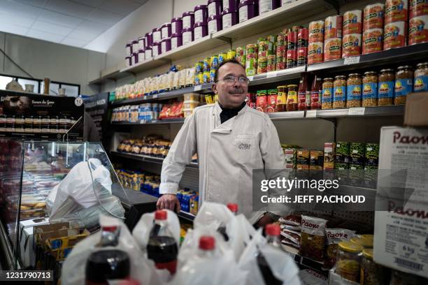 Butcher Mourad Slimani distributes food to students in need in his butcher shop in Venissieux, on March 18, 2021. - By presenting their university...