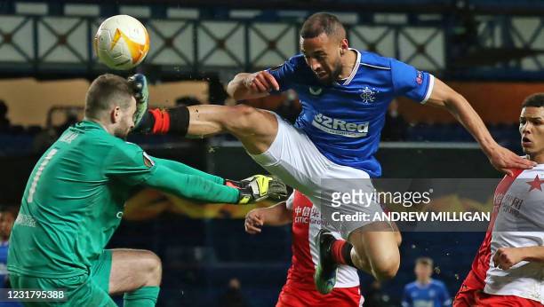 Rangers' English striker Kemar Roofe is sent off for this challenge on Slavia Prague's Czech goalkeeper Ondrej Kolar during the UEFA Europa League...